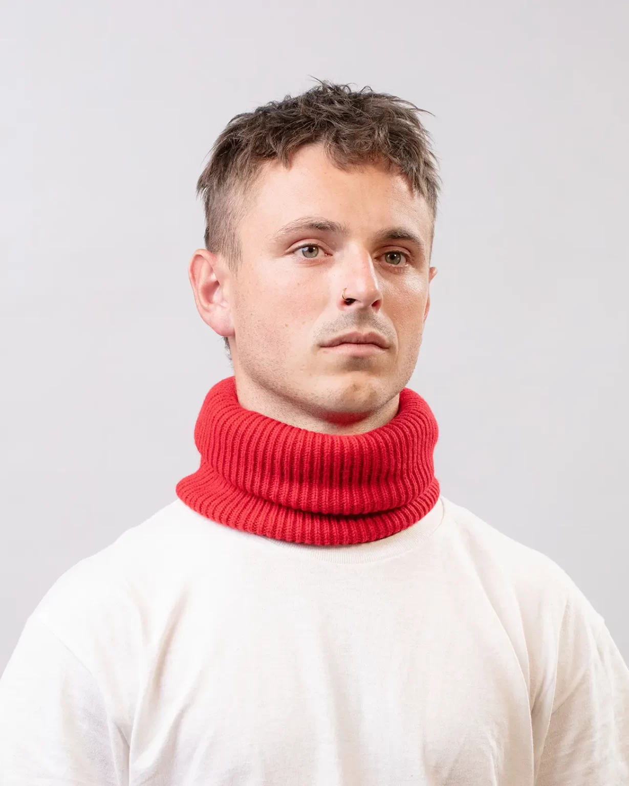 Photographie studio du Tour de Cou Cachemire Régénéré Rouge, porté par un mannequin Homme. Ce tour de cou est fabriqué en France, à partir de Laine et de Cachemire Recyclé, par la marque haut-de-gamme Maison Douillet. Cest un modèle pour Homme, Femme et Enfant.